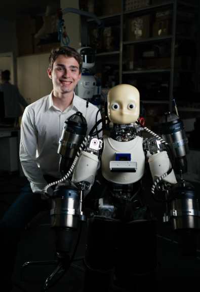 Lucas with a humanoid robot in a robotics laboratory
